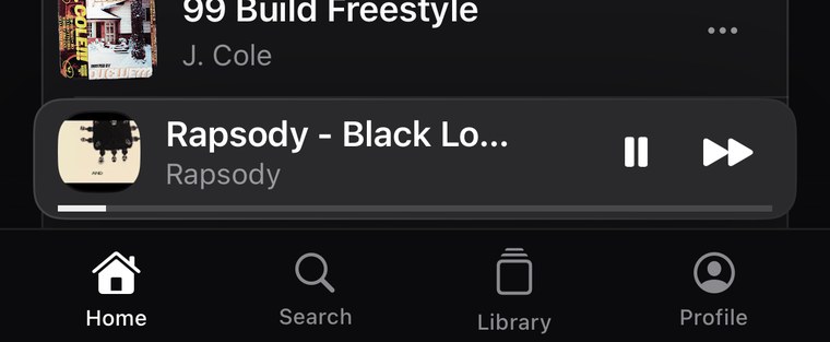 The mini player docked above the tab bar, playing.